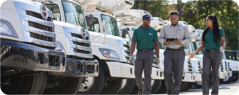 three people walking in front of their trucks three people walking in front of their trucks