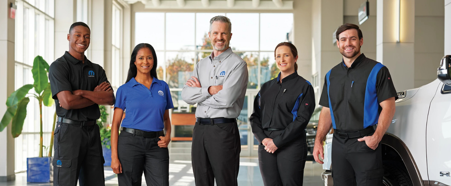 a team of auto dealership workers wearing branded MOPAR Red Kap workwear