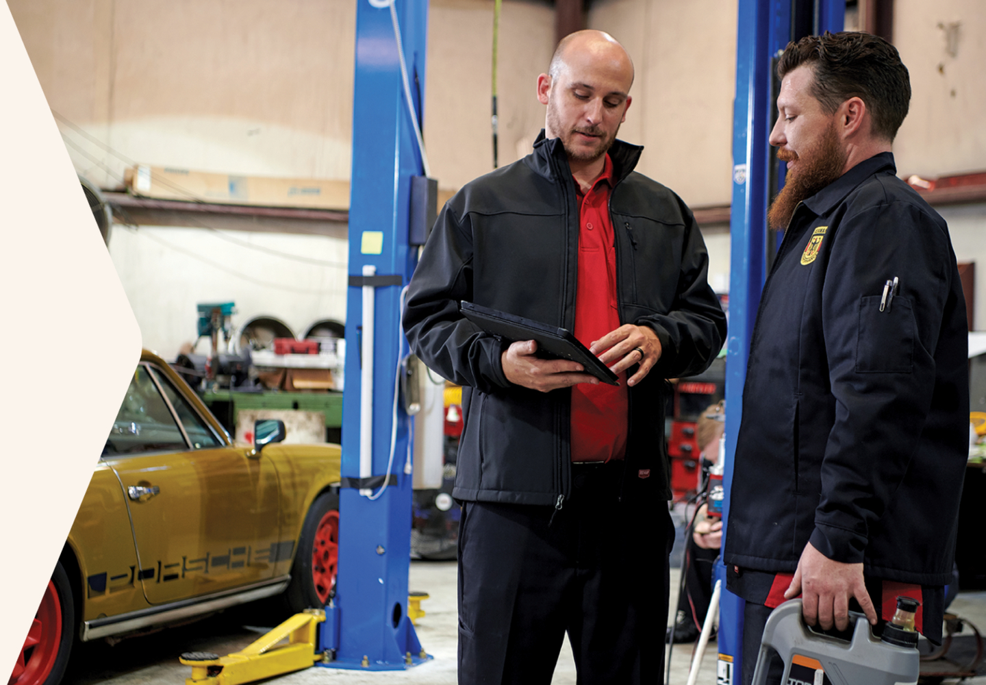 two workers in an autoshop wearing Red Kap workwear